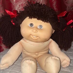 Adorable Brown-Haired Doll with Red Bows